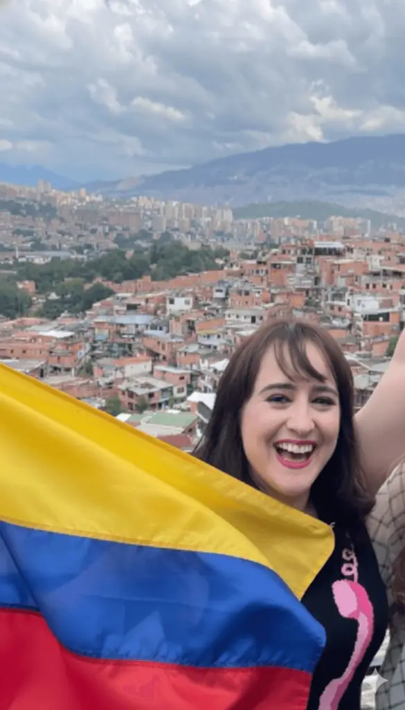 Maria Wilson holding the Colombian flag during her visit to La Comuna 13
